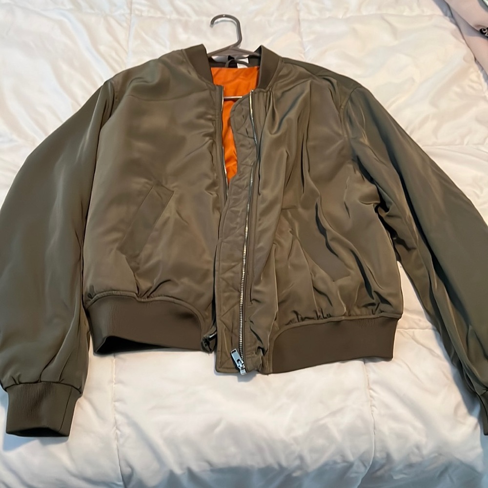 Large, H&M army green bomber jacket with orange interior. Water resistant.